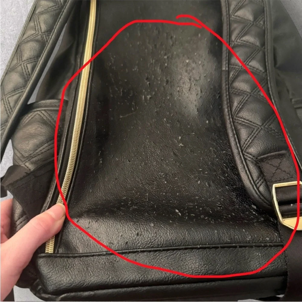 Itzy Ritzy Boss Plus black diaper bag backpack with gold hardware.